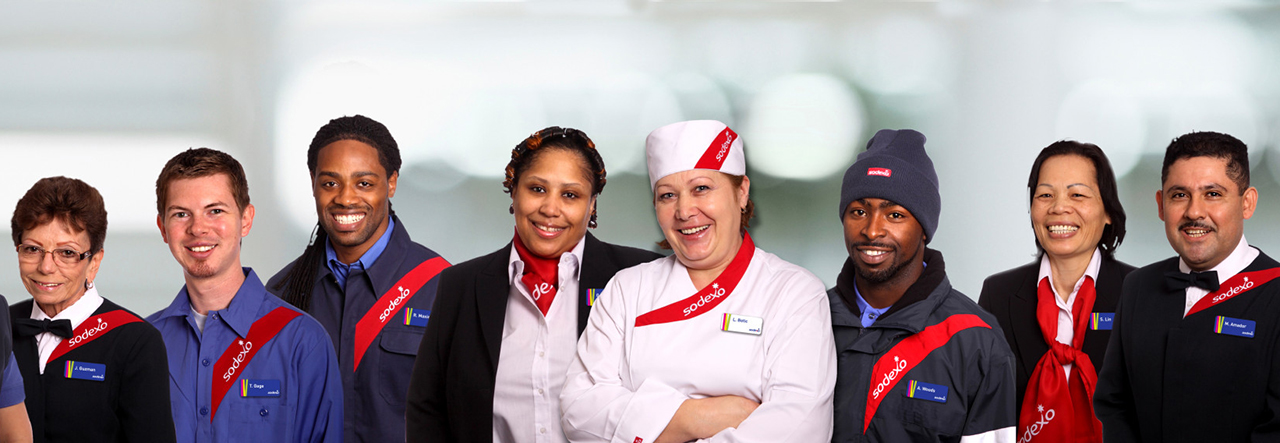 diverse group of sodexo employees wearing uniforms posing for camera