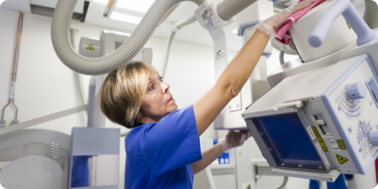 Hospital worker cleaning radiology machines 