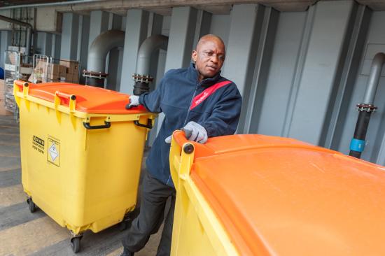 Sodexo employee moving waste bins